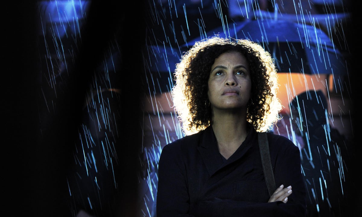 Woman stands in the rain