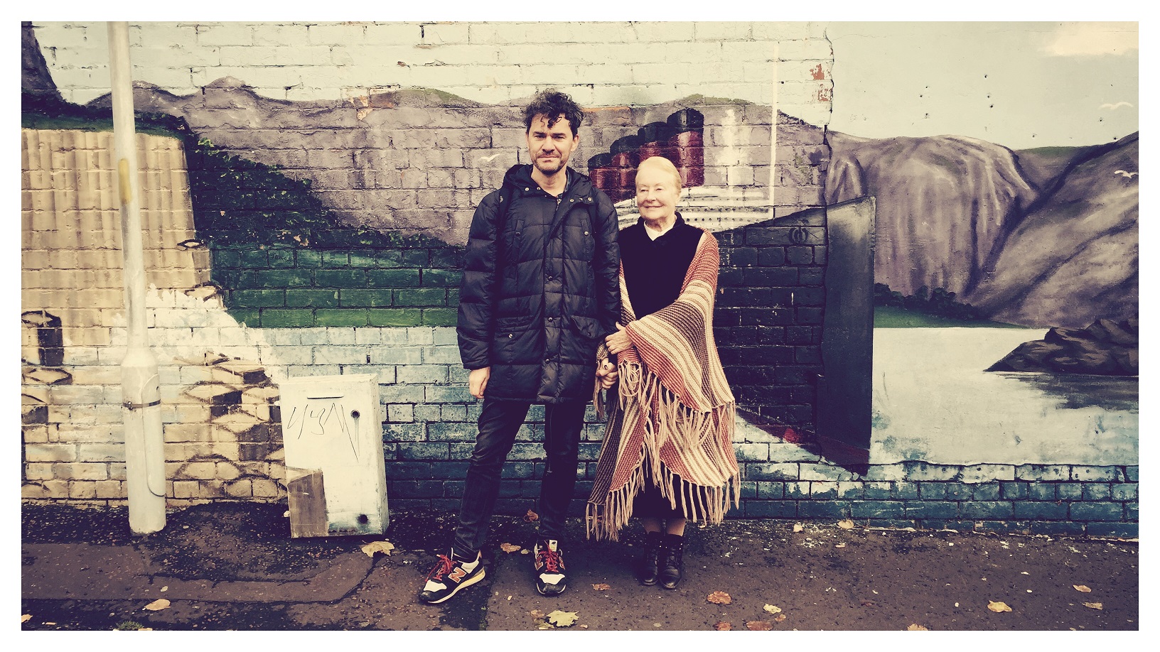 Mark Cousins and Helena Bereen stand against a wall