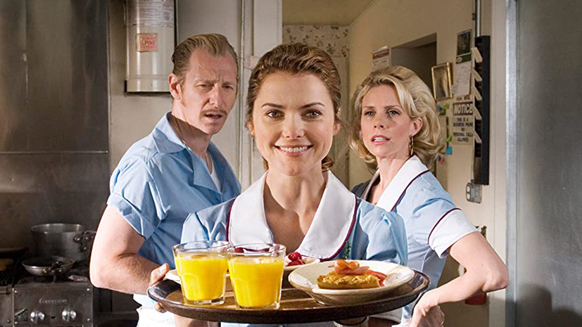 Still from Waitress, Keri Russell's character holds a tray in a diner kitchen